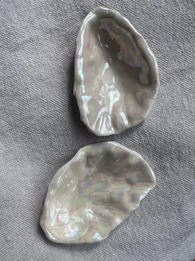 a pair of handmade pearl lustre porcelain oyster shells formed using a real oyster shell. Each one is unique.