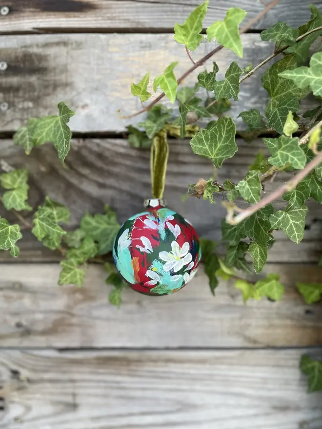  Unique hand-painted ceramic floral Christmas bauble featuring paper white flowers on a red background