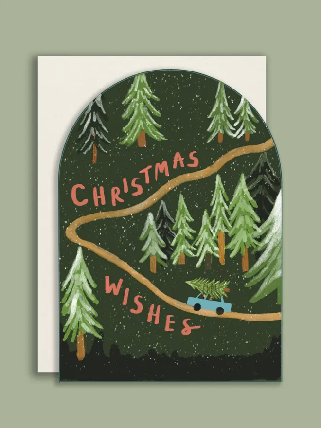 Arched shape Christmas card with white envelope, with an illustrated forest and a car with a Christmas tree