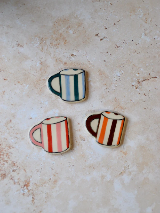 Handmade ceramic mug magnets — red and cream striped design