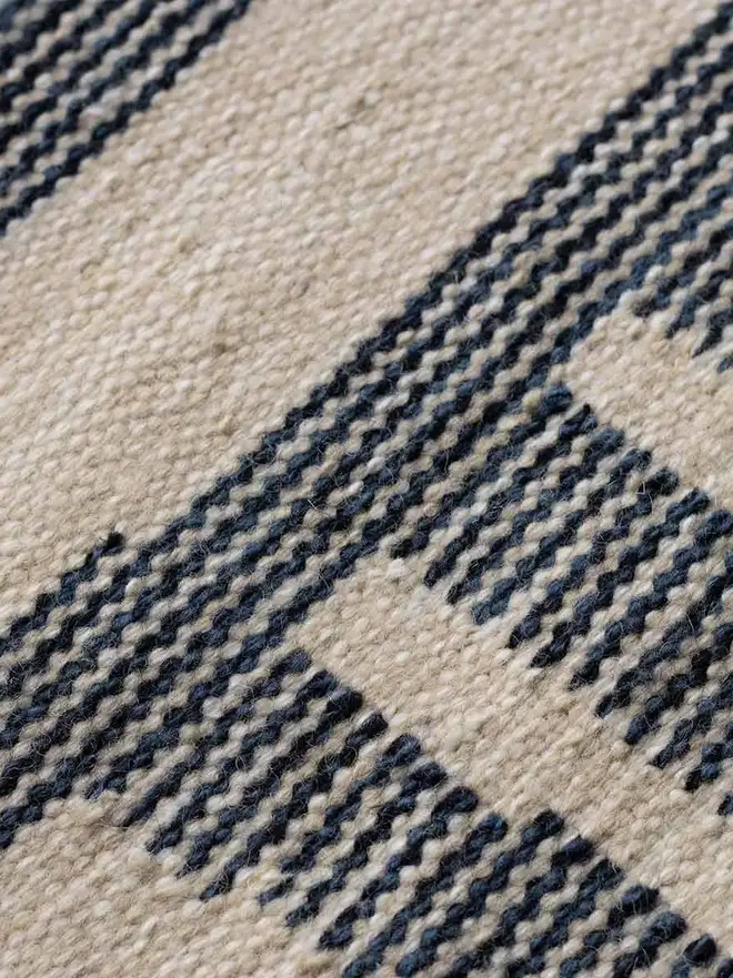 Tudor Flatweave Rug, a colourful rug in a living room. 