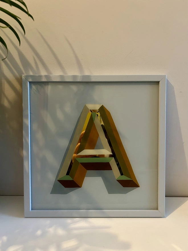 Gold leaf initial O Yellow checkered frame