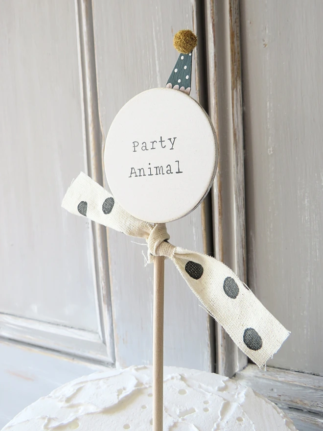 hand painted wooden cake topper with party animal message and hand made party hat