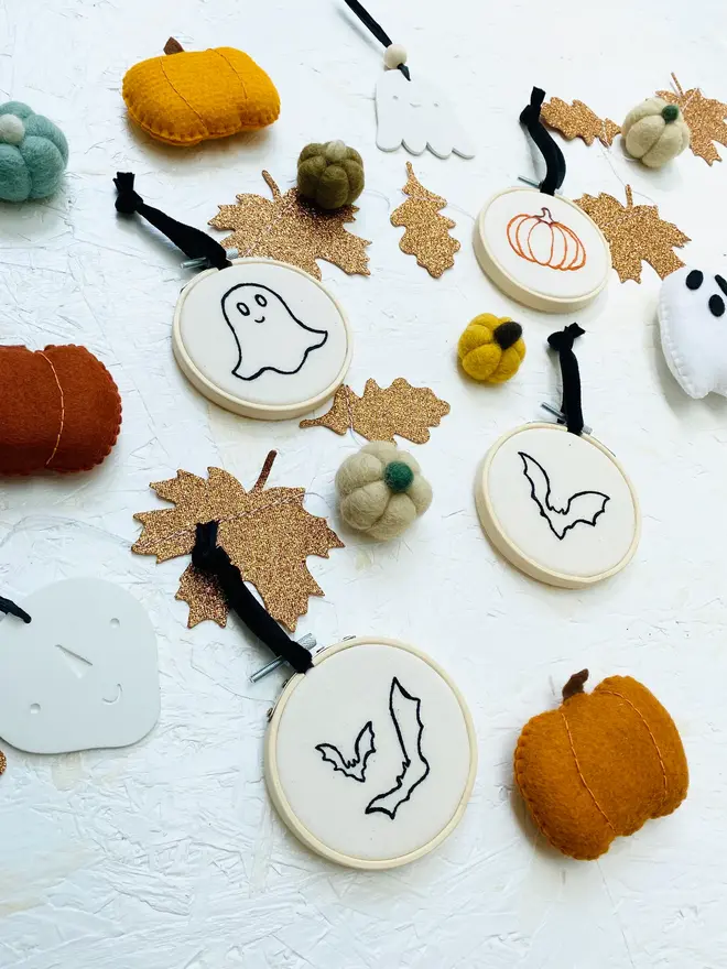 embroidered halloween mini hoop. assorted mini halloween hoops displayed on white background with decorations.