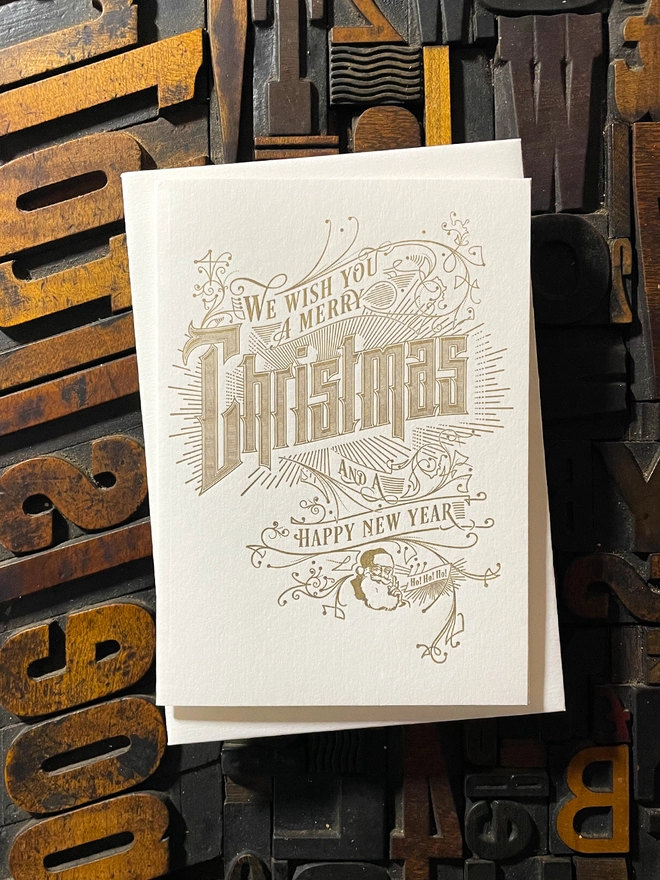 Spread festive cheer with this charming vintage Santa letterpress Christmas card! These cards are printed with my own fair hands on my 1915 Arab Crown Folio Press. Printed in metallic gold ink.