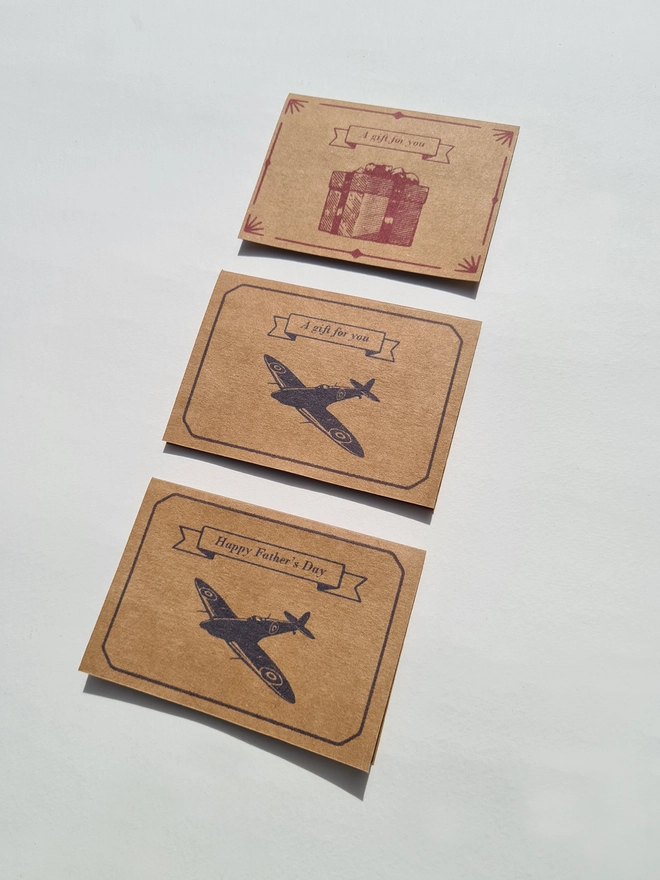 a selection of gift cards with a spitfire airplane or a red gift box