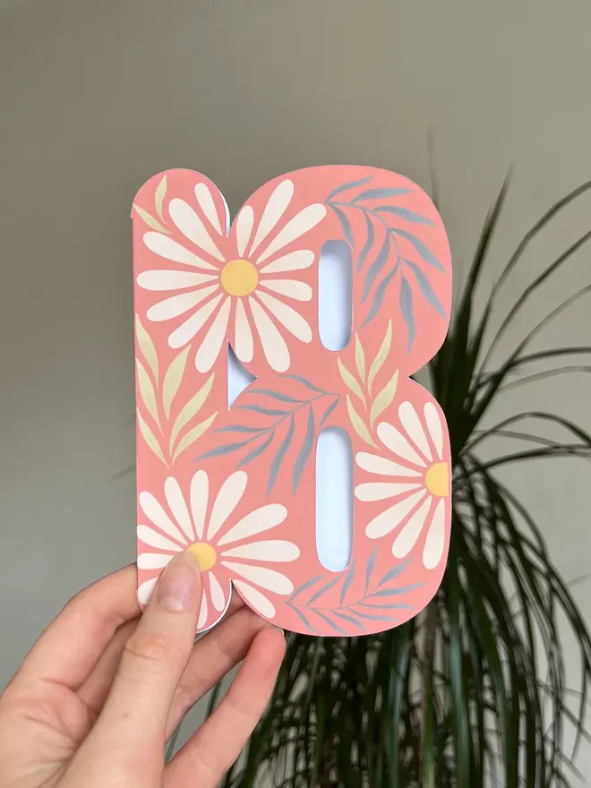 floral 18th birthday card. card shaped like number 18 with daisies and leaves.