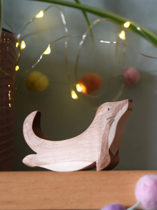 wooden swimming otter on shelf