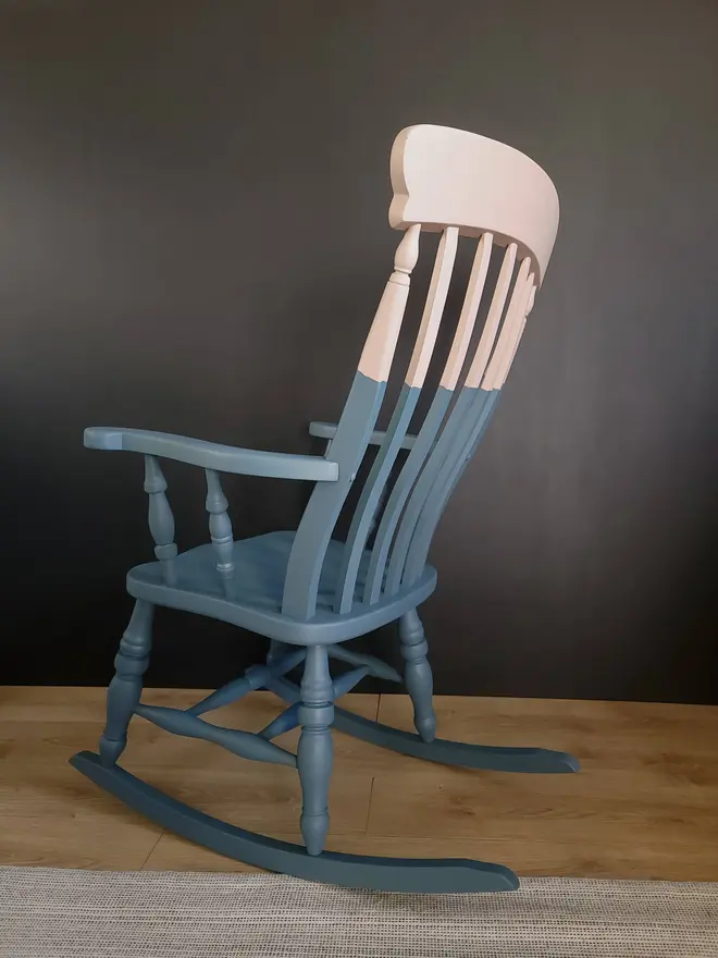 Back view of blue and pink rocking chair.