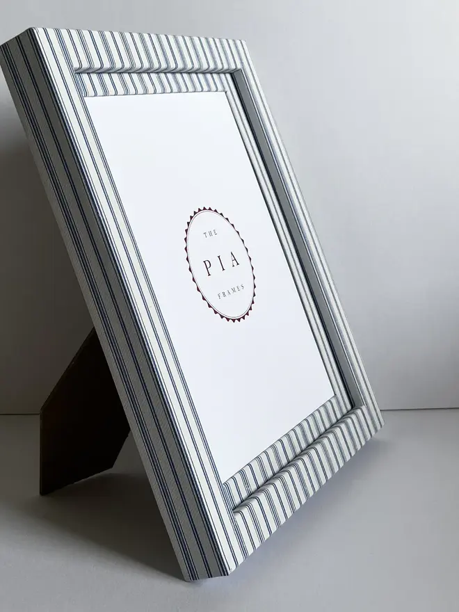 Rustic Blue Stripe Frame, a striped colourful frame sitting on a plain white surface. 