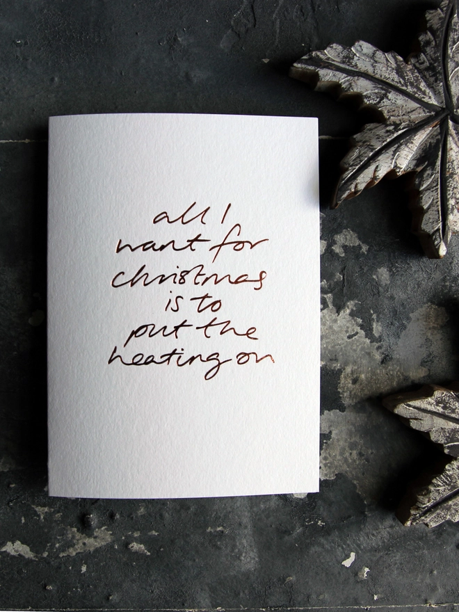 want to put the heating on white christmas card metallic script