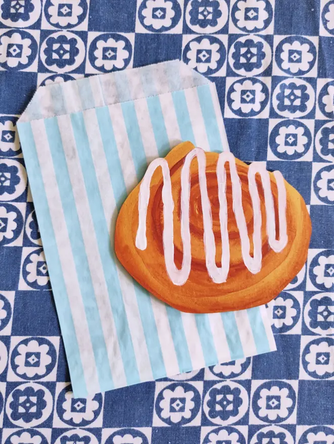 hand painted cinnamon roll cut out on striped paper