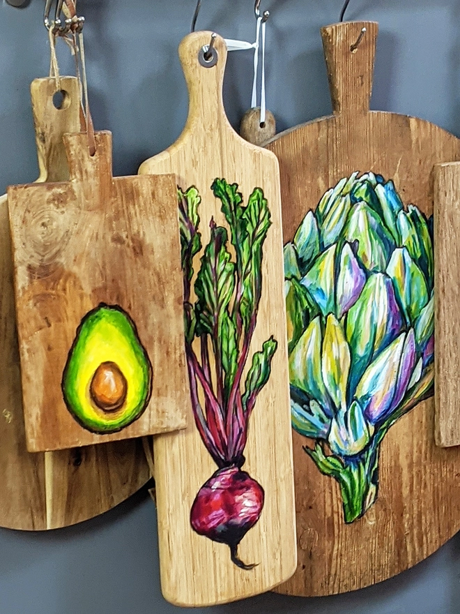 Handpainted serving boards hanging in kitchen