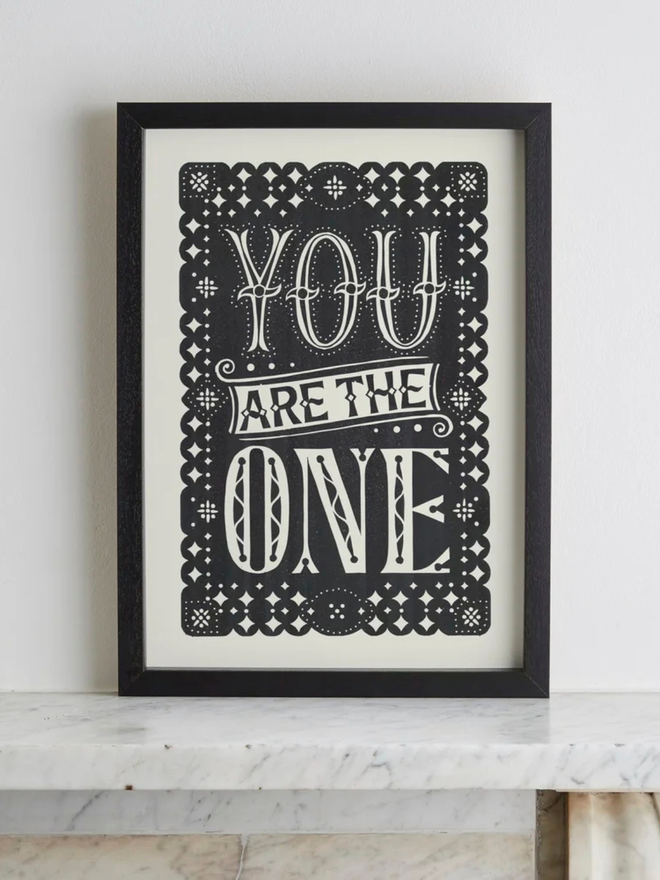 you are the one linocut. a linocut phrase printed on black paint.