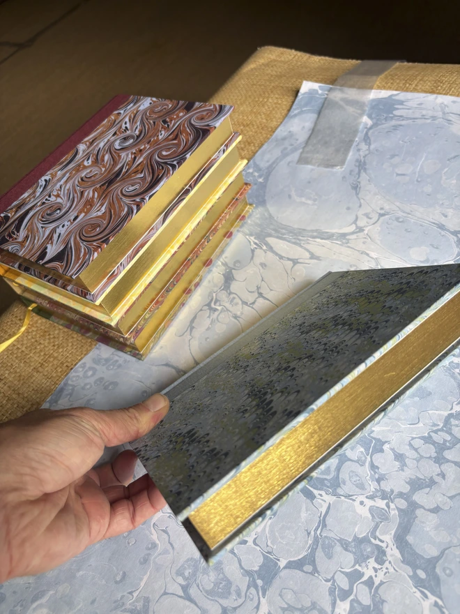 Group shot of 5 year diaries showing gold edge