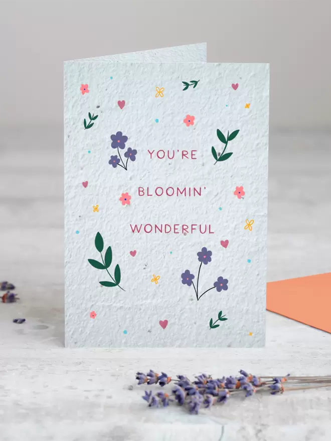 Seeded Paper Greeting Card with ‘You’re Bloomin Wonderful’ in the centre surrounded by floral illustrations with a sprig of Lavender placed in the foreground of the image