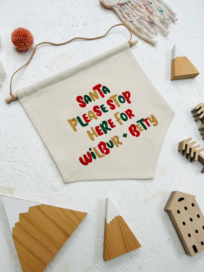 personalised embroidered santa stop here banner. cotton banner embroidered with festive colours.