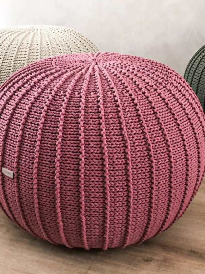 Zuri House. Large old rose knitted pouffe.