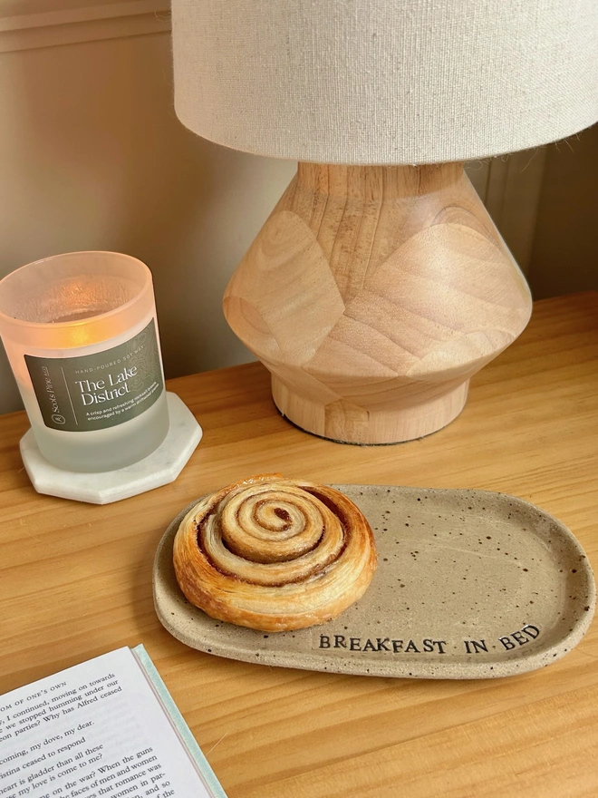 ceramic plate on a bedside table with a cinnamon swirl 
