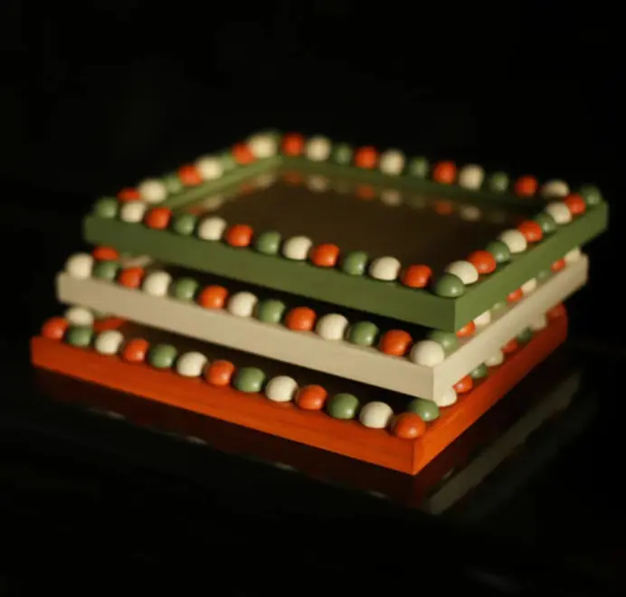 white orange and green bobbin frames