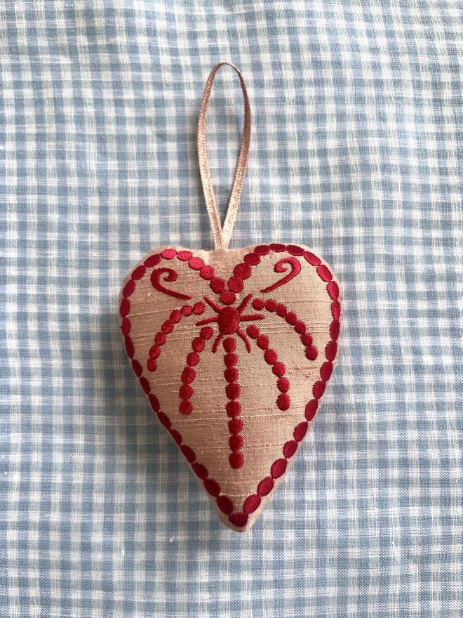 Silk heart ornament: pale pink silk, red thread, pink metallic ribbon