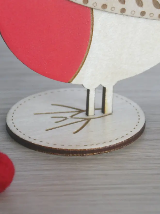 Standing Wooden Robin, red wooden bird decoration standing on a platform. 
