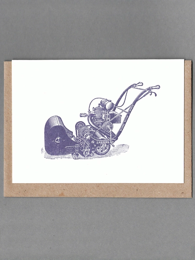 White card with purple illustration of a lawnmower with a brown envelope behind