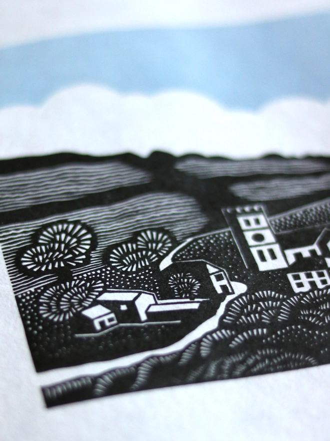 Original handmade linocut print featuring a Cornish village with a church, houses, fields and trees