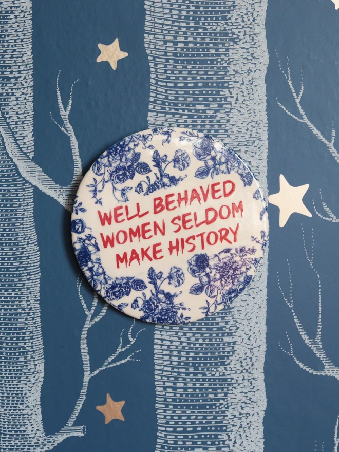 emma puddick pottery well behaved women plaque blue graffiti on wall