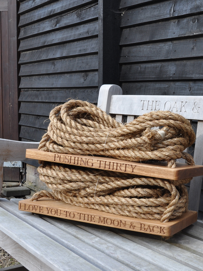 Two mediums size swings engraved with Pushing Thirty and To The Moon & Back