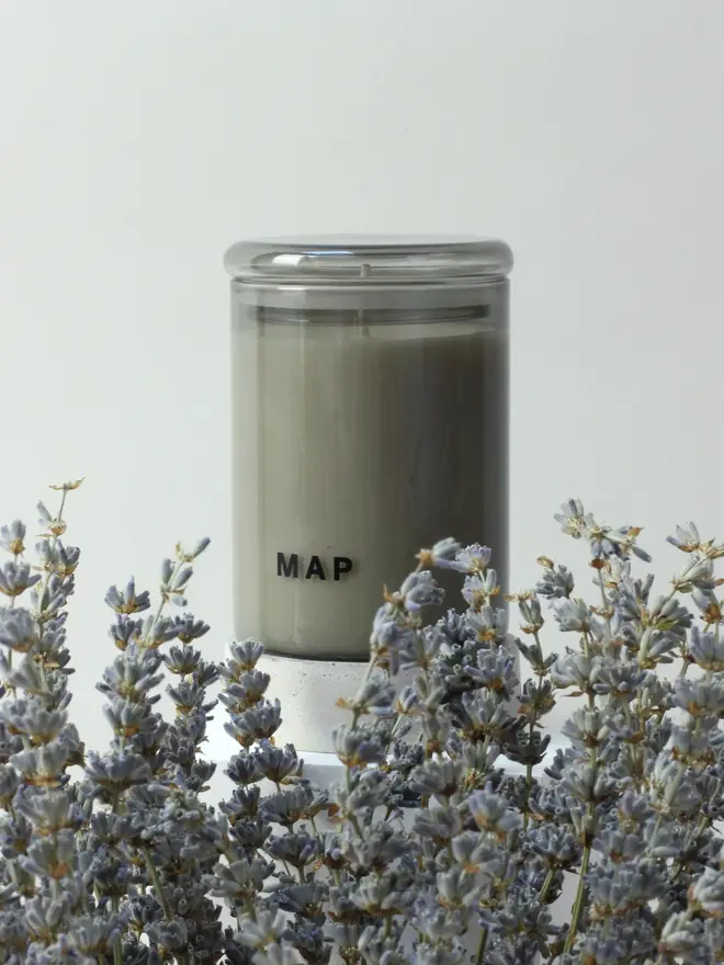 blue fields lavender and sandalwood candle. candle photographed with lavender in foreground.