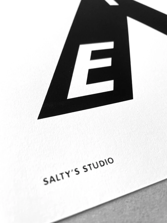 Bottom left corner close up of the A3 Exeter print, showing the Salty’s Studio name printed. The print sits on a greyboard background