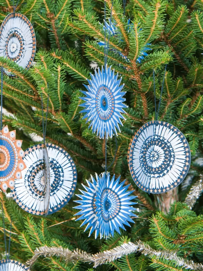 Paper stars hanging on Christmas tree