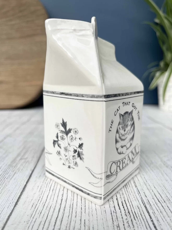 ‘The cat that got the cream’ is humorously written on a handmade ceramic cream carton.