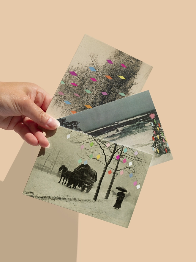 A mixed set of Christmas cards featuring snowy landscape scenes where the trees are decorated with colourful geometric baubles.