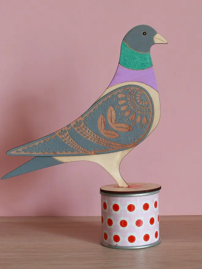 Standing Wooden Pigeon, wooden bird decoration standing on a platform. 