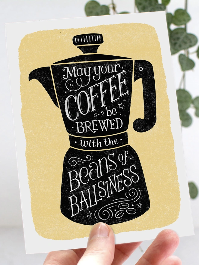 black coffee cup on yellow background with white hand lettered coffee quote inside