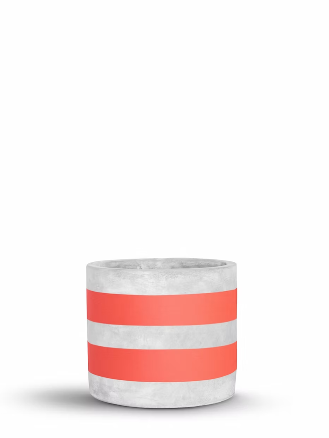 two stripes concrete plant pot. a grey plant pot with coral painted stripes.