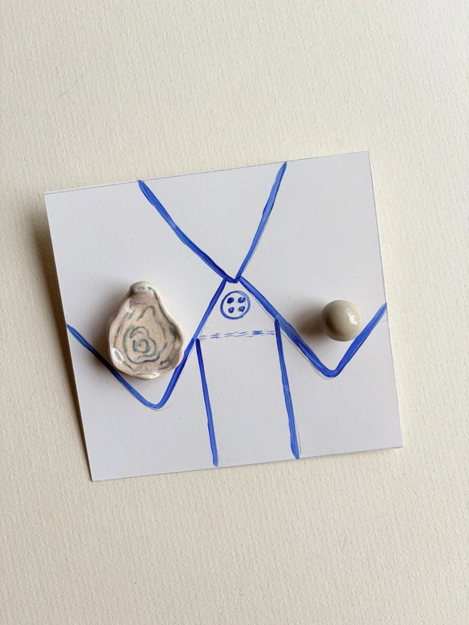 Foodie collar pins. An oyster and a pearl collar pin on a collar hand-sketched on paper