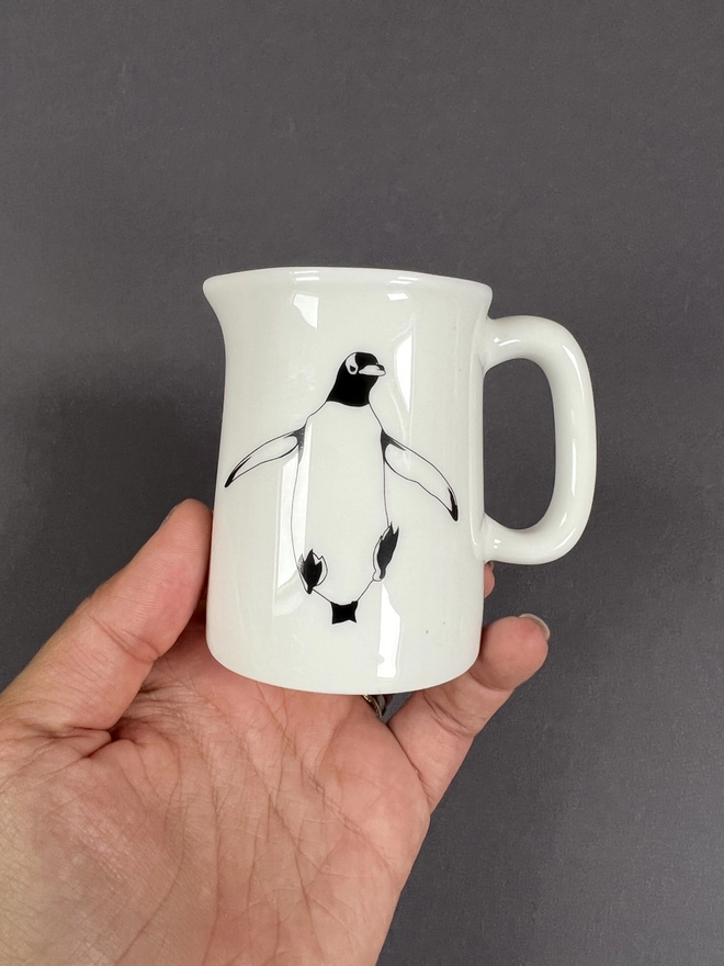 Front of the penguin quarter jug showing the jumping Gentoo design