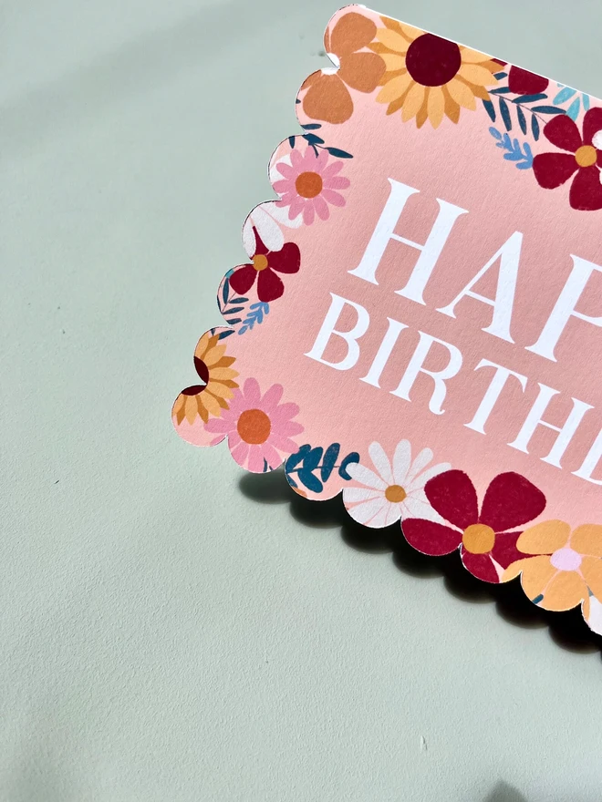 floral happy birthday card. scallop edged birthday card with illustrated flowers.