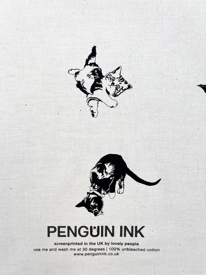 Close up of the Penguin Ink logo with two adorable cat illustrations around it