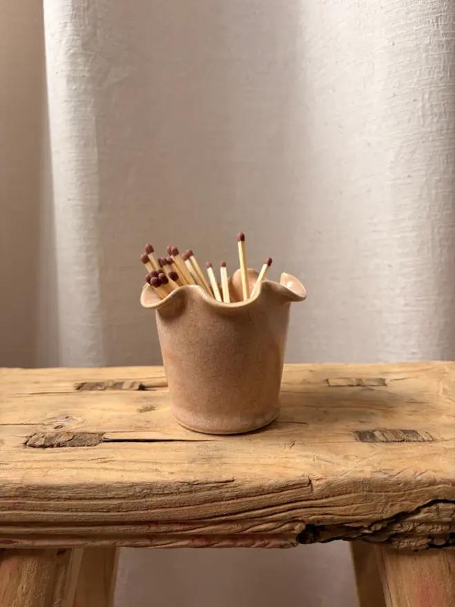  Frilly Matchstick Pot holding matches, on wooden stool
