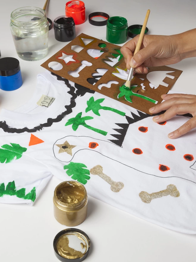 Stencilling onto a design your own dinosaur t-shirt