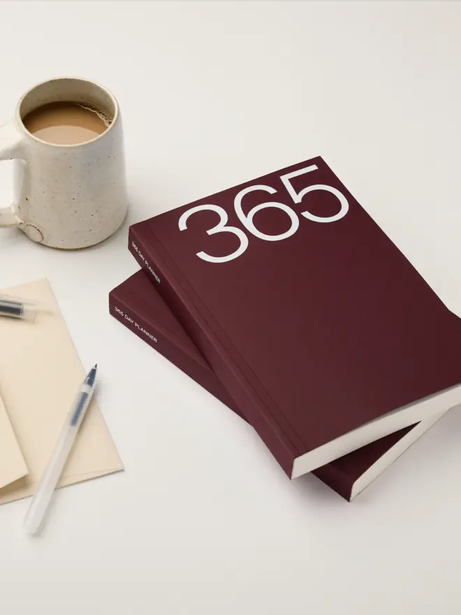 Claret coloured softcover, smooth untextured cover stock. Foiled with a white 365. A5 in size