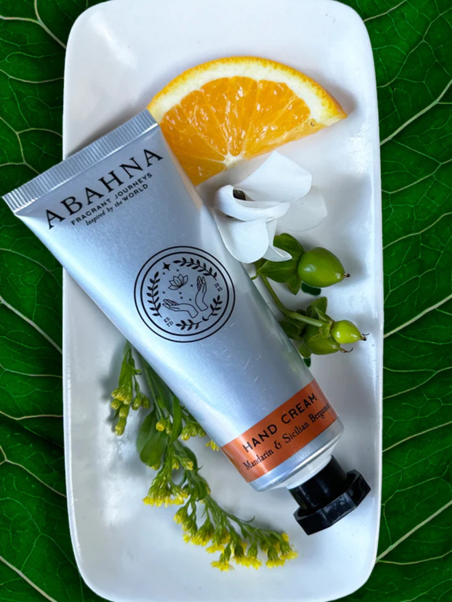 mandarin and sicilian bergamot botanical hand cream. a silver tube containing hand lotion.
