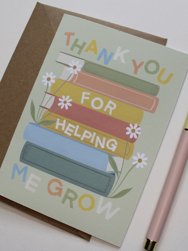 'thank you for helping me grow' illustrated card. green card with illustrated books and flowers.