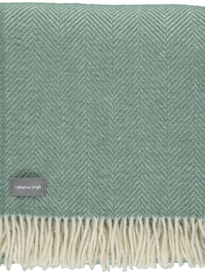 Organic Wool Throw, an organic wool throw folded on a white surface. 