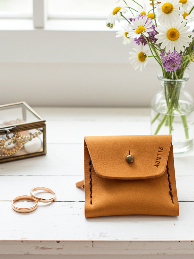 yellow mini  ring purse with a vase of flowers