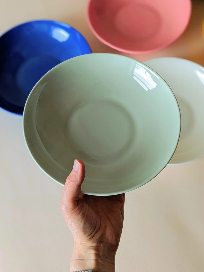 Glossy Glazed Inside of Porcelain Hand Made Pasta Bowl in Rockpool Light Green Held in Hand